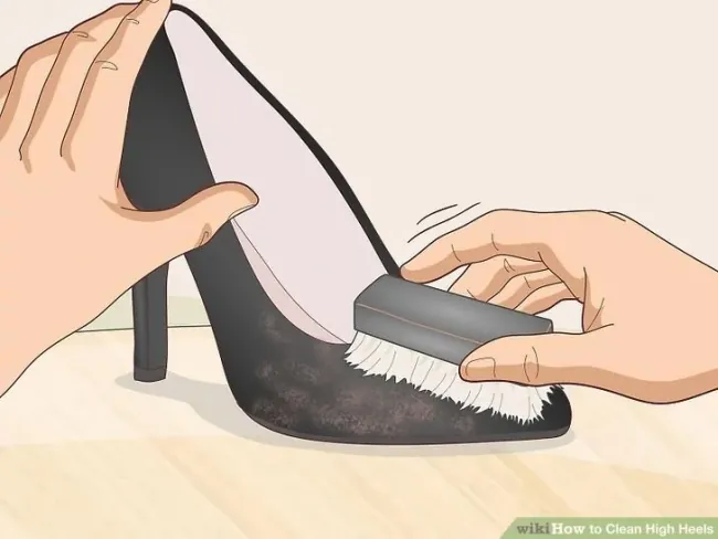Brushing suede on a high heel with a dedicated brush