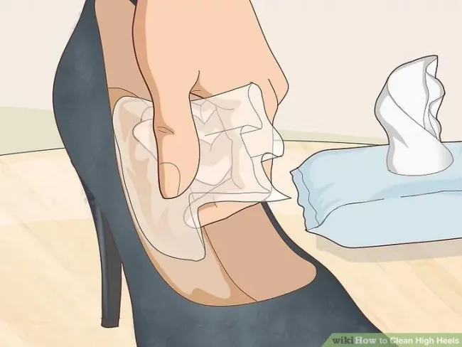 Wiping the inside of a high heel with a damp cloth