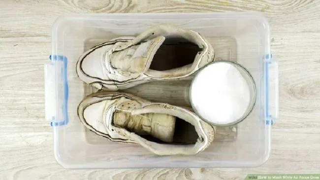 Baking soda deodorizing shoes inside a sealed container