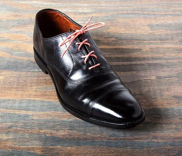 A black leather oxford after polishing, with a glossy toe box