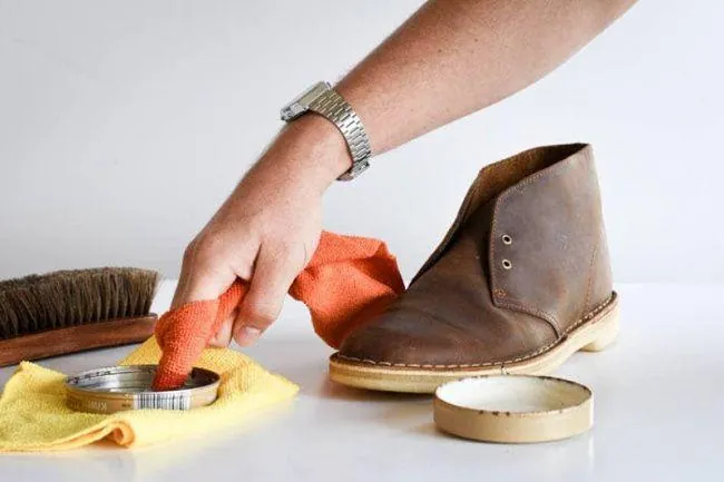Applying a suede waterproofing spray to dry, clean Desert Boots